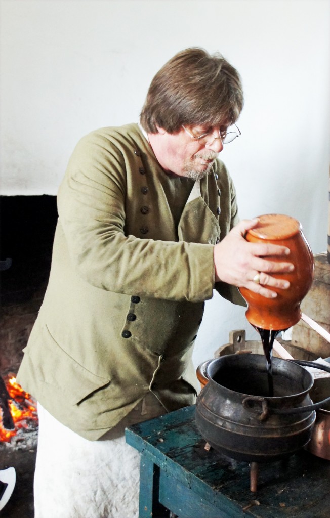 Addng the molasses to the iron pot before heating it to make essentia binae, porter colouring. (This was illegal for commercial brewers, but fine for home brewers) 