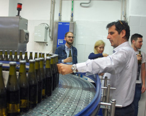 Menabrea brewery managing director Franco Thedy pulls a bottle out of the line