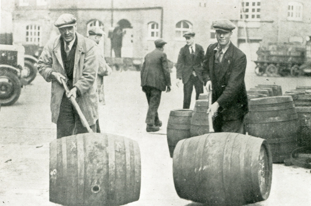 Rolling barrels in the Mortlake brewery yard 1932