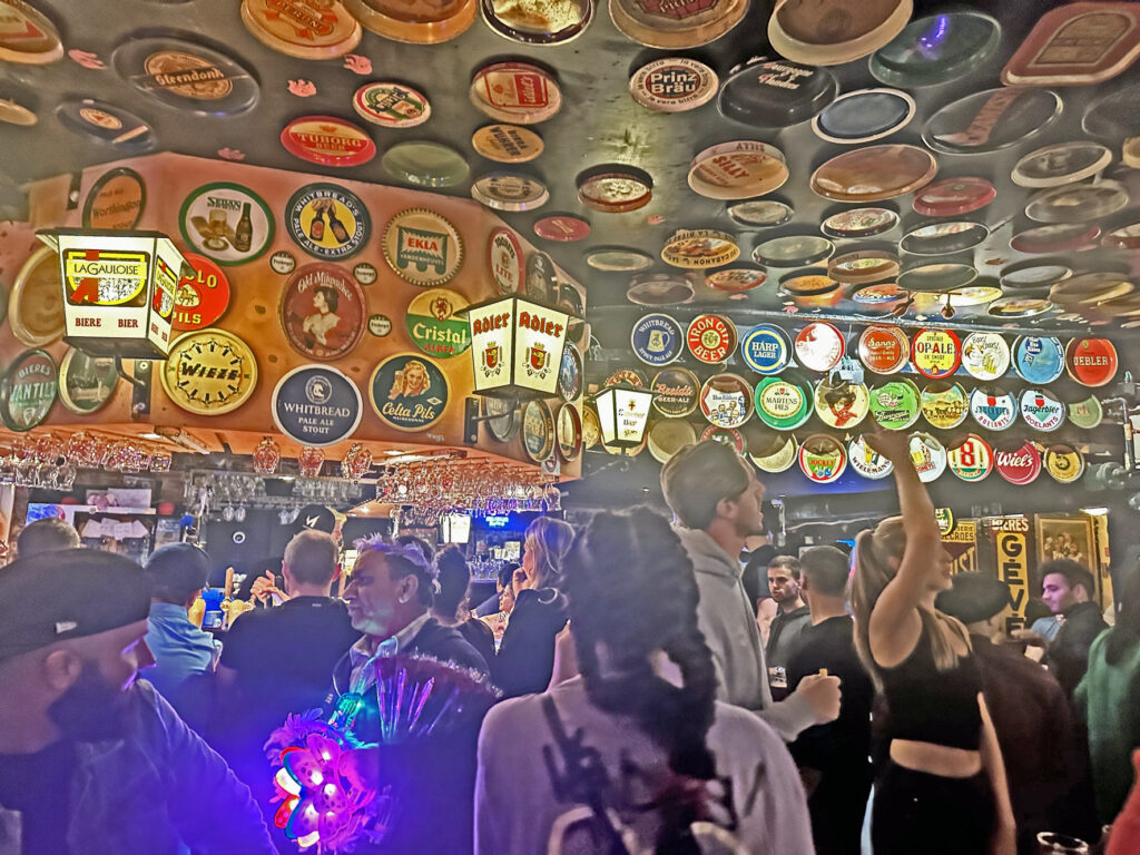 Interior of Delerium cafe with brewery trays all over ceiling